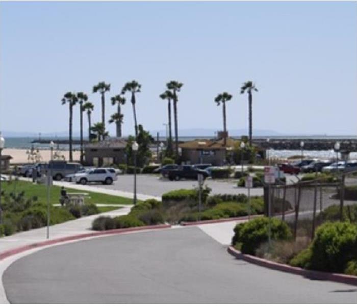 View of Seal Beach; building and street in foreground; beach in background