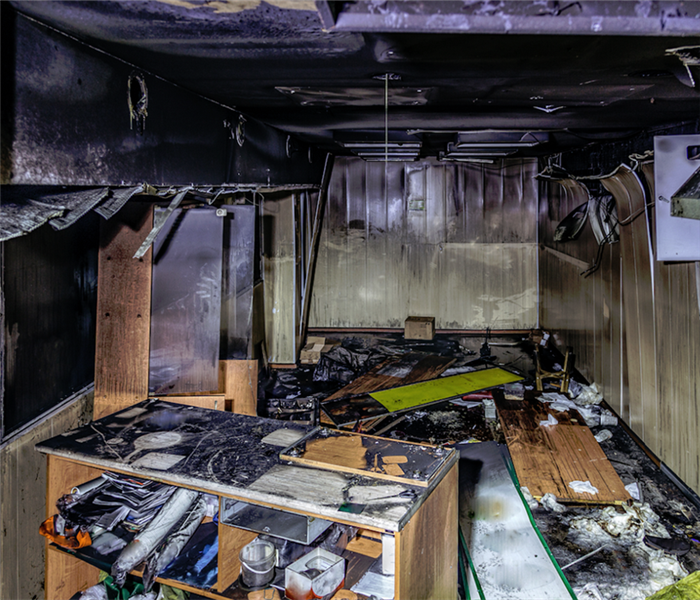 a fire damage room with soot covering the walls